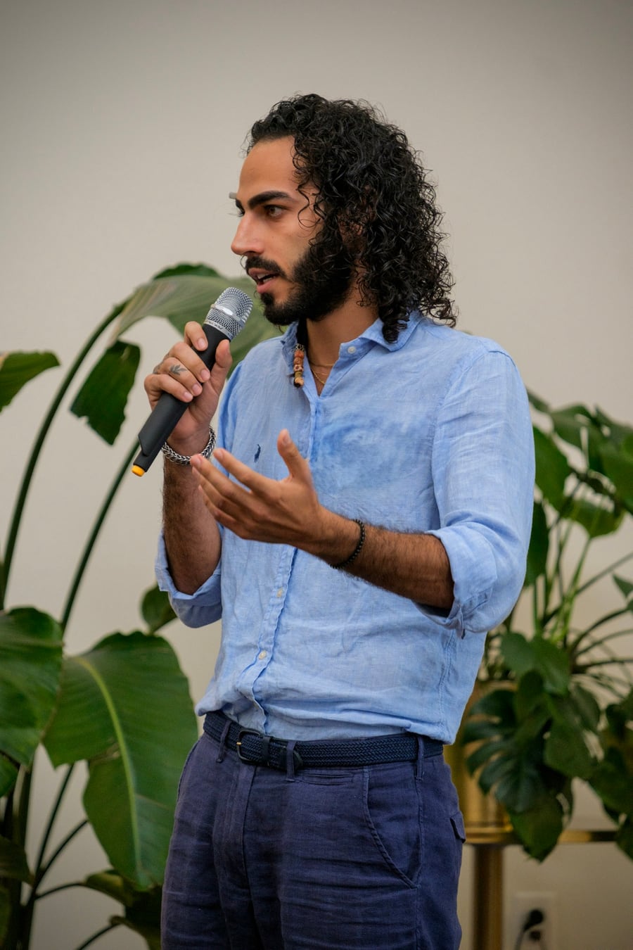 Adam Shlomi speaking into a microphone